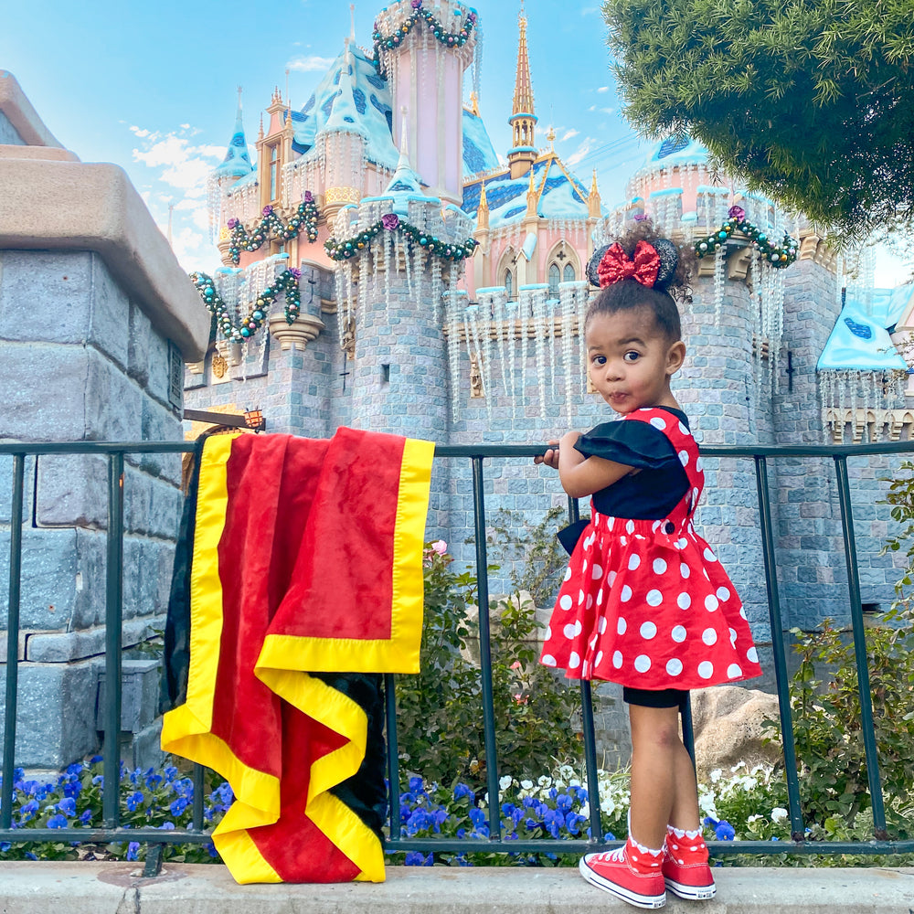 Mickey Mouse inspired minky blanket in front of Sleeping Beauty's castle in Disneyland